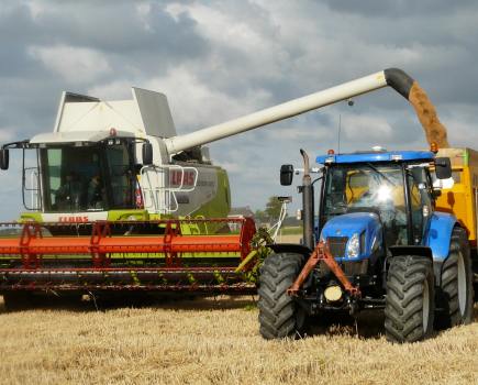 Tractor and combine in a field