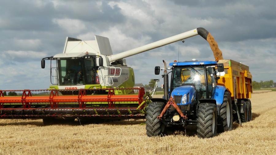 Tractor and combine in a field