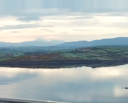 A landscape image of Mulroy Bay in Ireland showing a large body of wter and a sky with clouds.